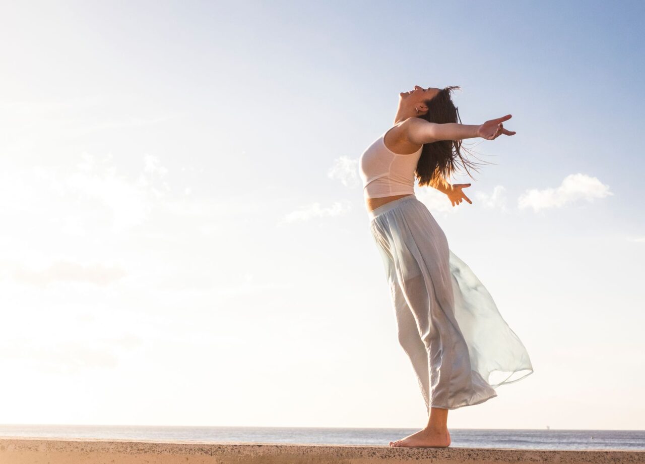 Freedom and empowerment female concept with young girl standing