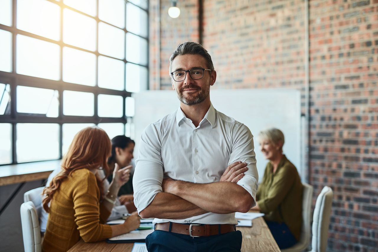 Portrait, business and man with arms crossed, startup success and leadership skills. Face, happy male person and manager with confidence, collaboration and teamwork with partnership and innovation