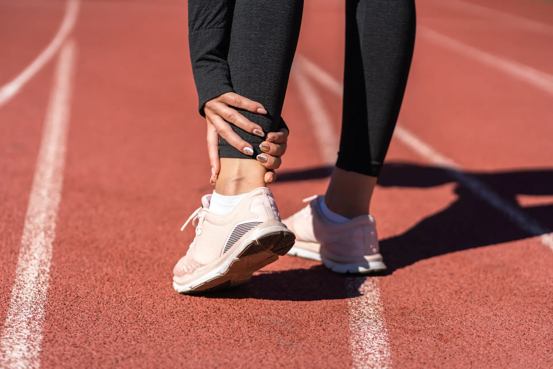 Woman Holding Her Ankle While On Running Track 2026 03 19 22 55 15 Utc