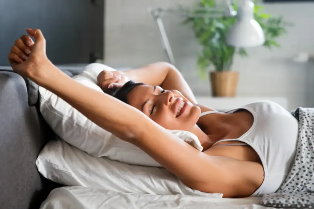 Woman Stretching And Smiling In Bed In The Morning 2026 03 23 23 31 58 Utc
